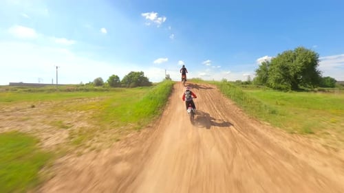 Dirtbikes Jump On Sunny Green Motocross Course