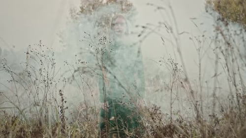 Model posing with smoke in field of flowers