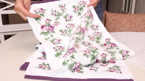 The Woman Makes A Review Of The Purchase. Lays Terry Towels On The Table. Close Up.