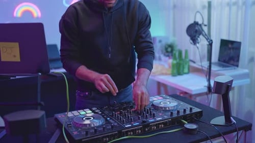 Man Mixing Music on DJ Controller Board