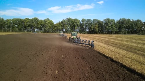 Tractors plowing the field in Ukraine
