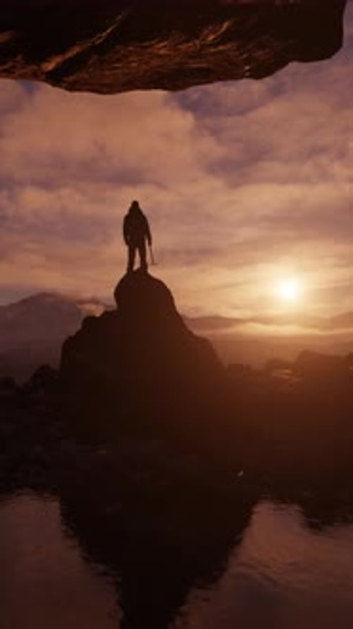 Man Standing on a Rocky Peak at Sunset Inside a Cave. Vertical animation