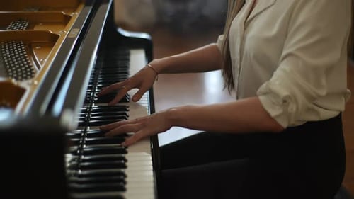 Woman Plays Piano in a Home