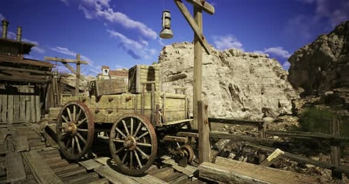 Viejo vagón de madera descansando cerca de un cañón rocoso bajo un cielo azul brillante