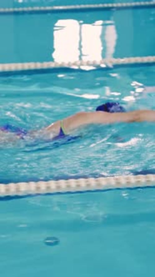 Sportswoman Swimmer Swims Along the Swimming Lane in the Pool in Freestyle A Slender Beautiful Woman