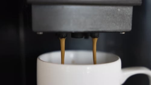 Close Up View Of Fresh Hot Coffee Being Poured In Cup. Slow Motion