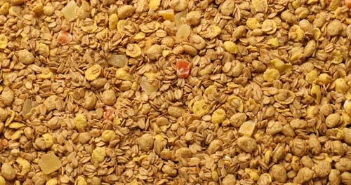 Tasty granola with dried fruits as background, top view