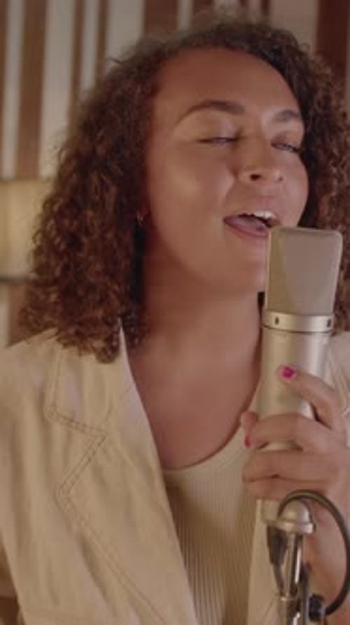 Female Singer Rehearsing in Music Recording Studio