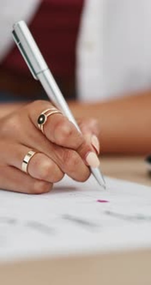 Woman Writes on Calendar with Silver Pen