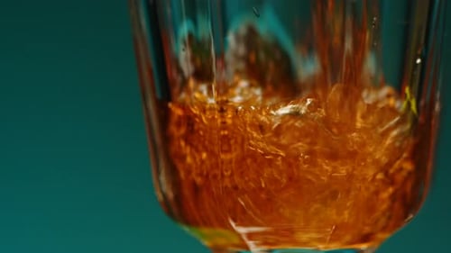 Amber Liquid Being Poured Into a Glass