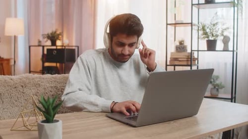 Young Man Working at a Laptop at Home