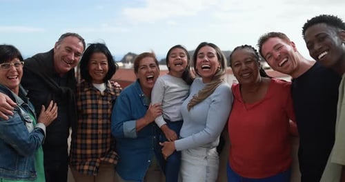 Diverse Group of People Smiling Together Outdoors in Daytime