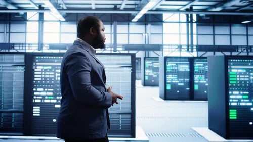 IT Specialist Doing Evaluation of Data Center Workspace