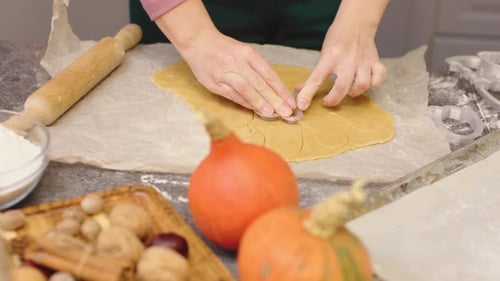 Cutting Out Pumpkin Shaped Holiday Cookies at Home