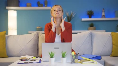 Home office worker woman looks at camera with happy and smiling face.