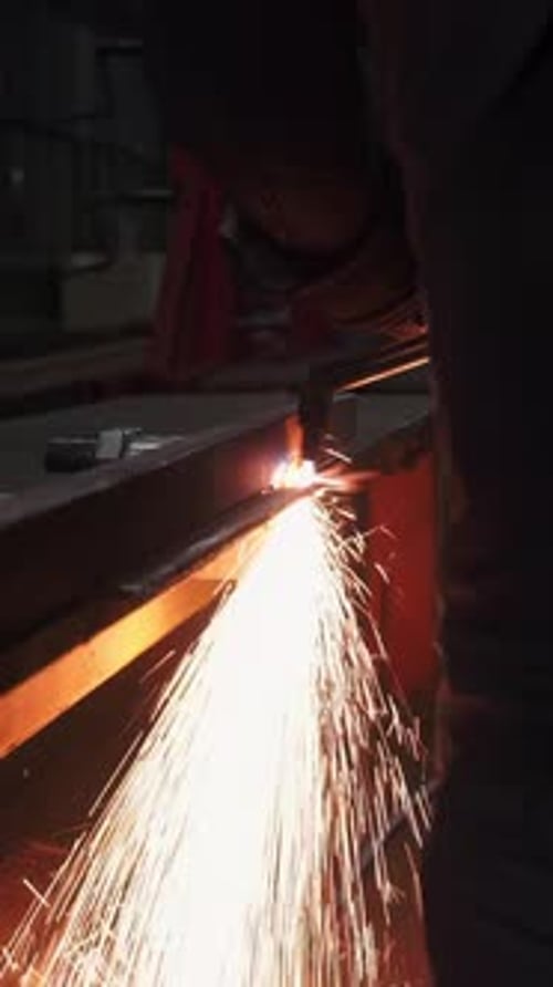 Metal Cutter Sparks Flying in the Dark Workshop