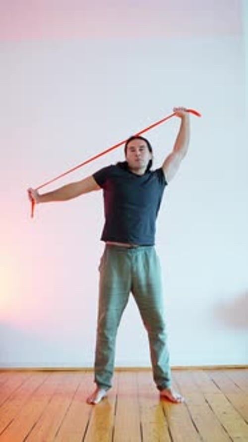 A Fitness Enthusiast Engaged in a Stretching Exercise Using a Resistance Band for Improvement