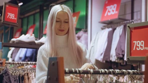 Young Woman Shopping for Clothing in Store
