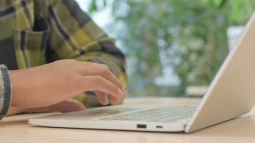 Hands of African Man Typing E-mail on Laptop