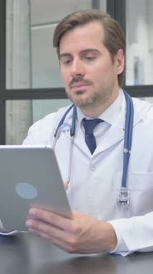 Young Doctor Using Digital Tablet in Hospital, vertical video
