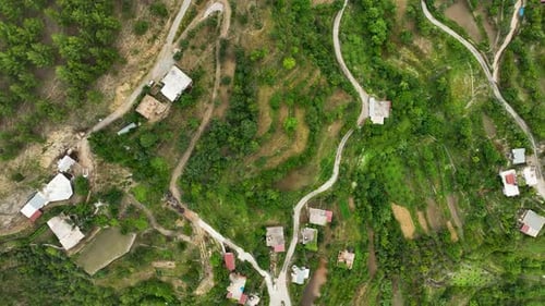 Aerial View Vibrant Greens Surround a Historic Mountain Village
