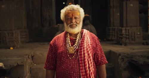 Senior Man in Traditional Dress in Temple