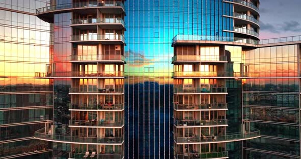 Mirror windows of modern multi-storied high-rise block of flats ...