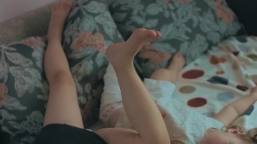 Mother and Child Playing on Couch Indoors