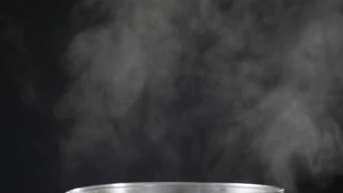 White Steam Billowing Against Black Background