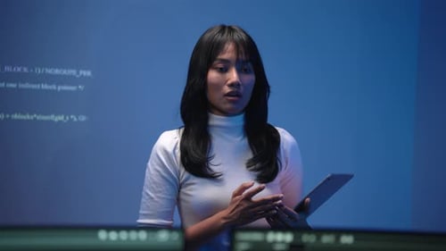 Female Developer Holding Tablet While Teaching Programming