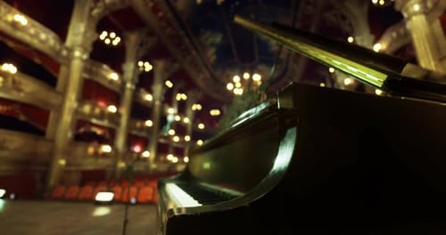 Elegant Grand Piano Positioned on Stage in Ornate Theater Interior