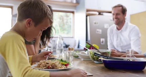 Boy and Family Enjoying Pasta Meal Together