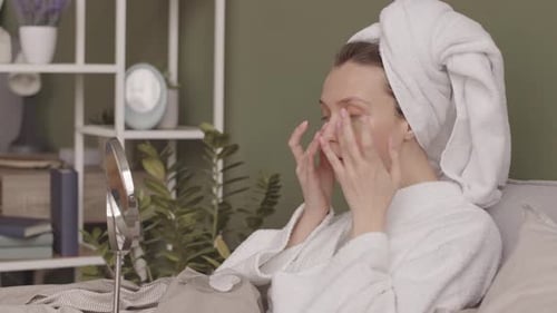 Woman Applying Beauty Patches in Bedroom
