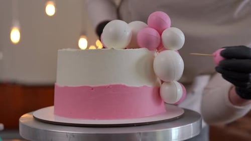 Decorating Birthday Cake with Round Pink and White Toppers
