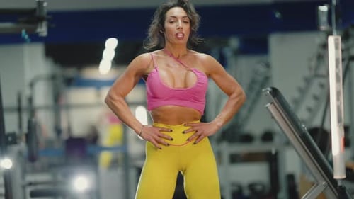 Muscular Woman Resting After Intense Deadlift Workout in a Gym