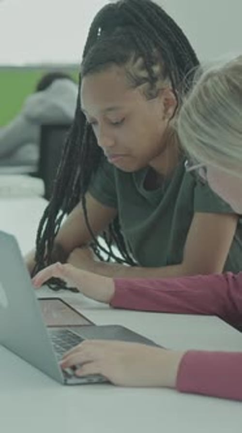 Two Female University Students using Laptop in Library Learning