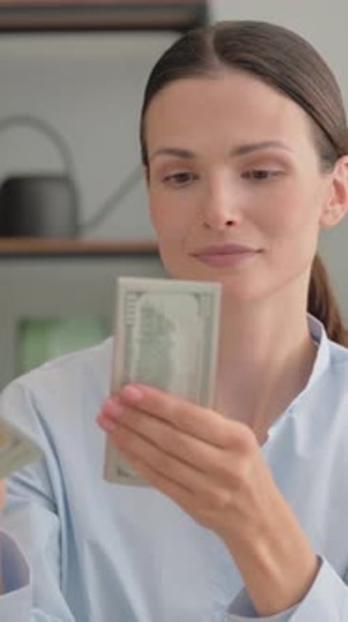 Woman Counts Money, One Hundred Dollar Bills