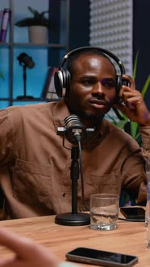 Young Adult Man Hosting Podcast in Studio