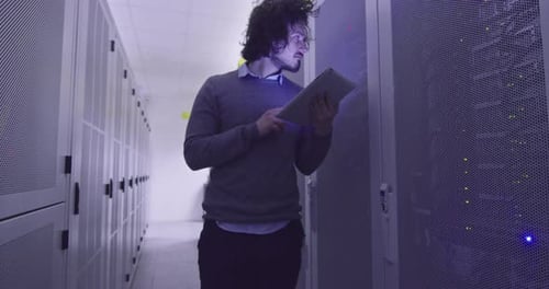 Young Adult Working in Data Center with Tablet