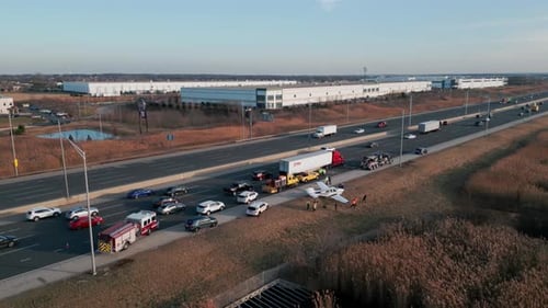 Wide Drone Shot of Emergency Airplane Landing on Highway