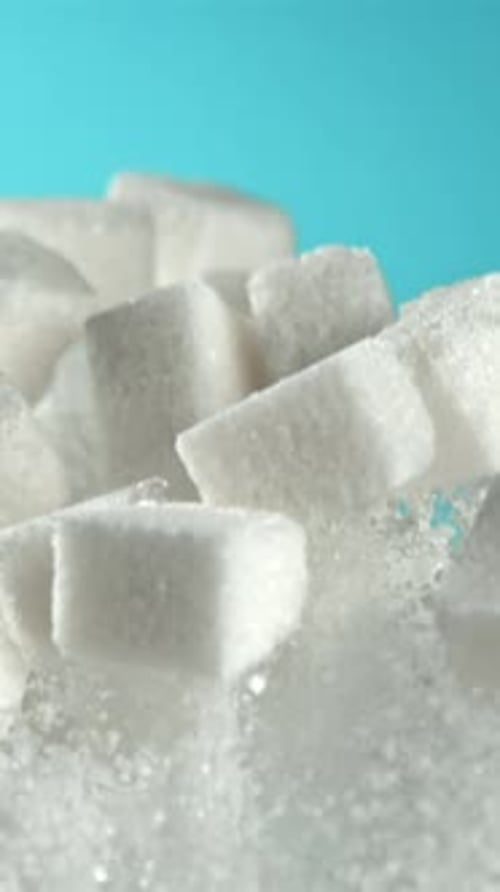 Cubes of Sugar Fly Up and Fall Down on a Blue Background Filmed on a Highspeed Camera at 1000 Fps