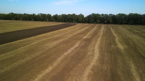 Tractors plowing the field in Ukraine