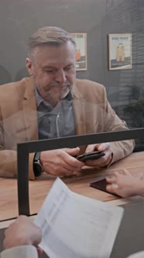 Man at Bank Gives Passport and Signs Form