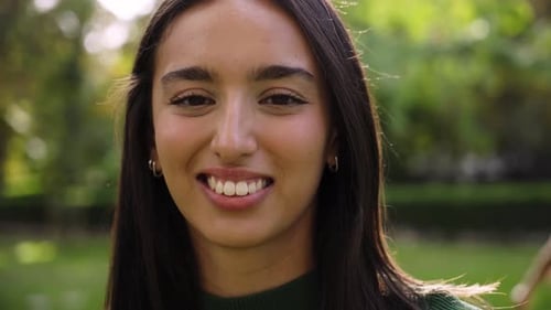 Smiling Young Adult Woman In Nature Close Up