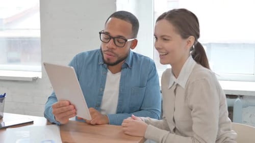 Adults Chatting With Tablet Waving in Office