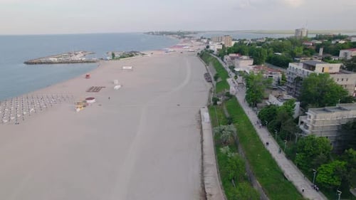 Drone view of beach and ocean with waves. Sea waves rolling on clean sand beach.