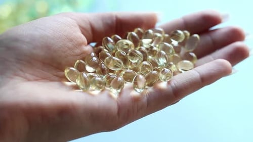 Close-up medicine yellow transparent pills, omega 3 fish oil capsules, vitamin D