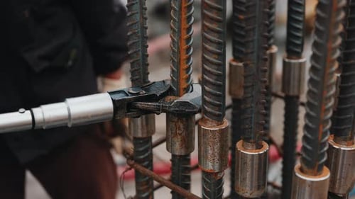 Worker Tightening Rebar Couplers with Wrench During Reinforcement Assembly