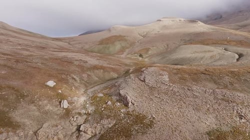 Aerial View Revealing Jagged Mountain Peaks Rising Through Misty Cloud Layers Capturing Dramatic