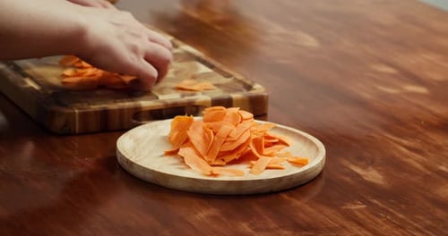 Preparing Freshly Sliced Carrots on Wooden Plate